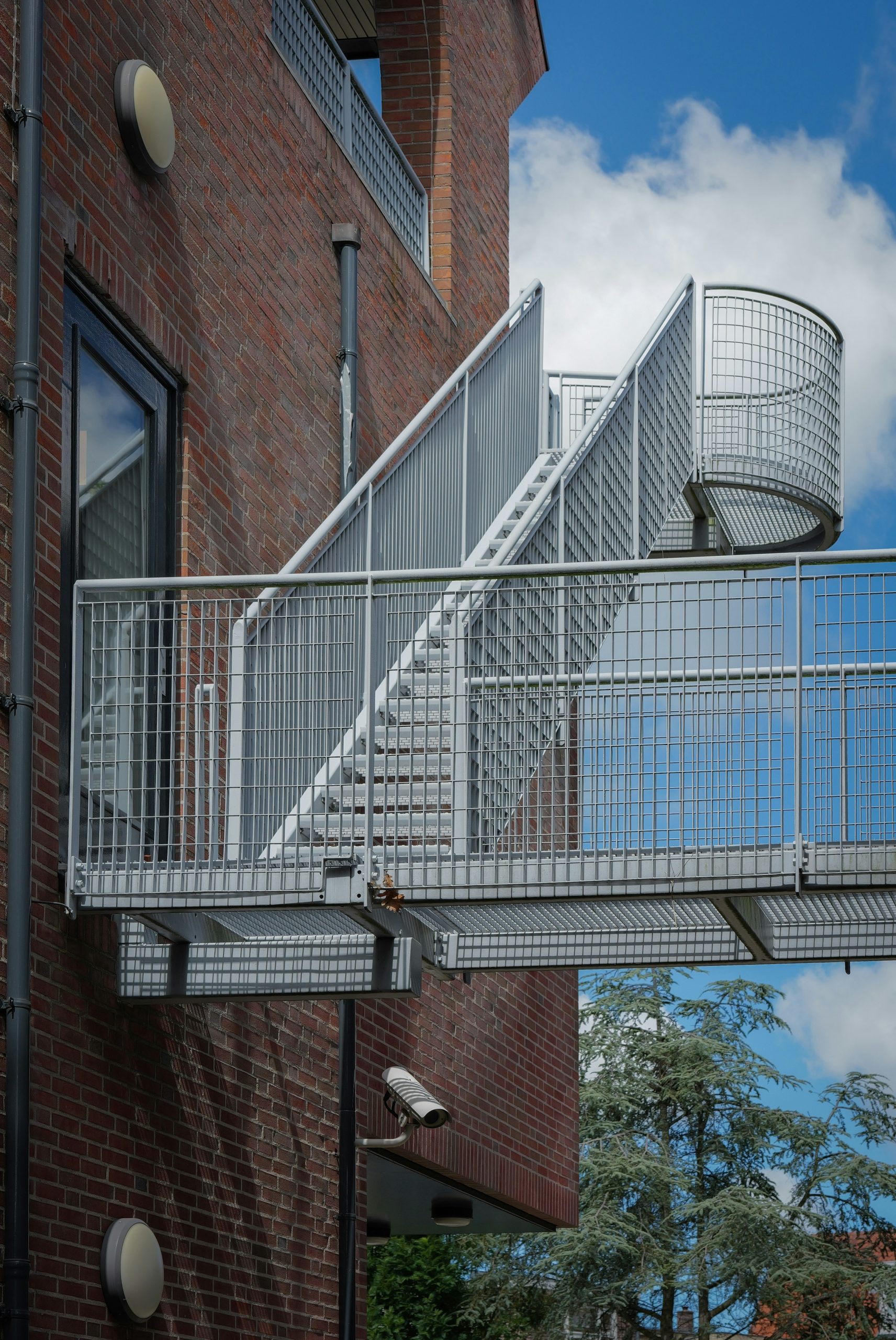 Metal staircase and walkway on a red brick building.