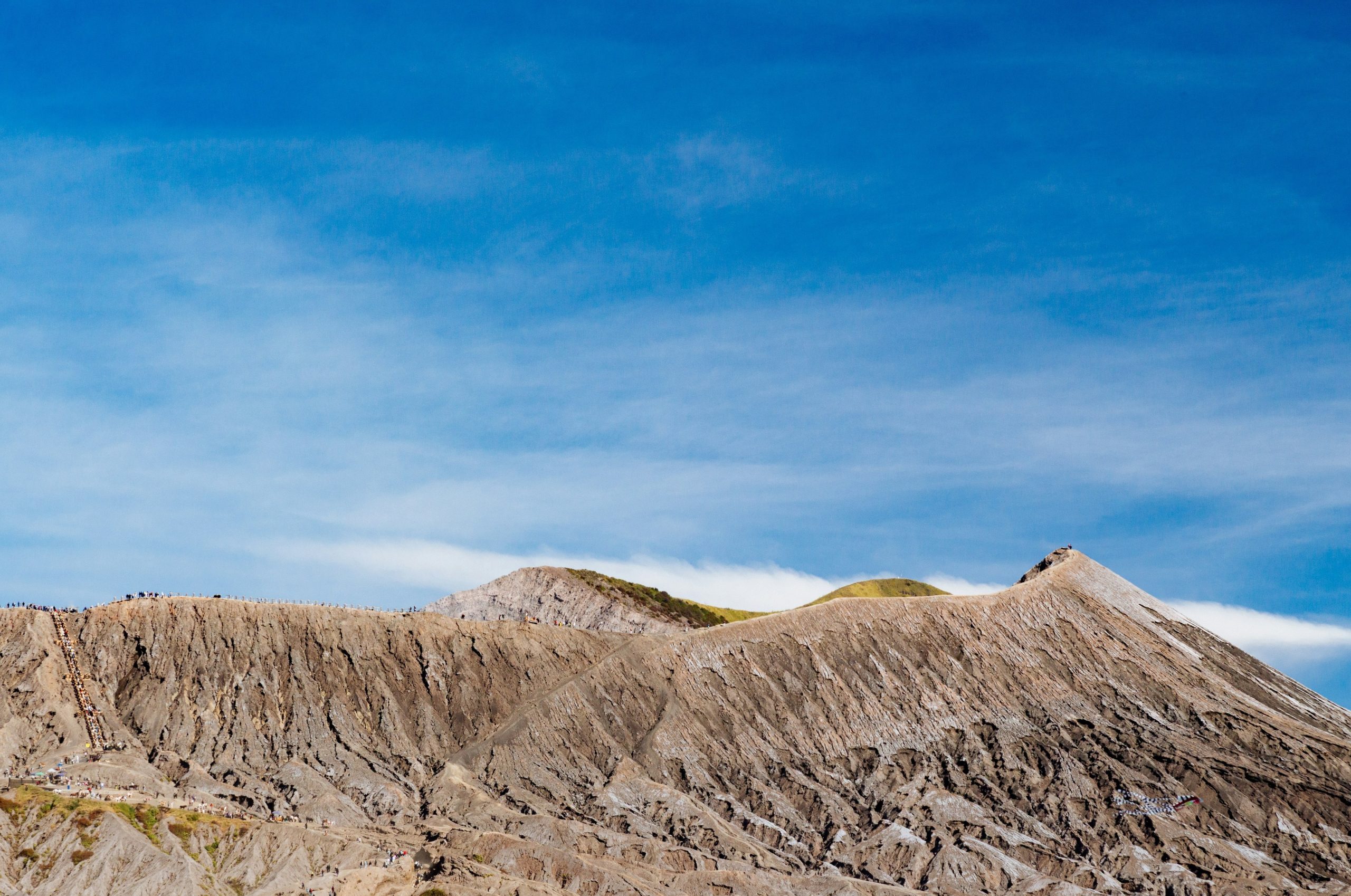 Rugged mountain peaks under a vast, clear blue sky.