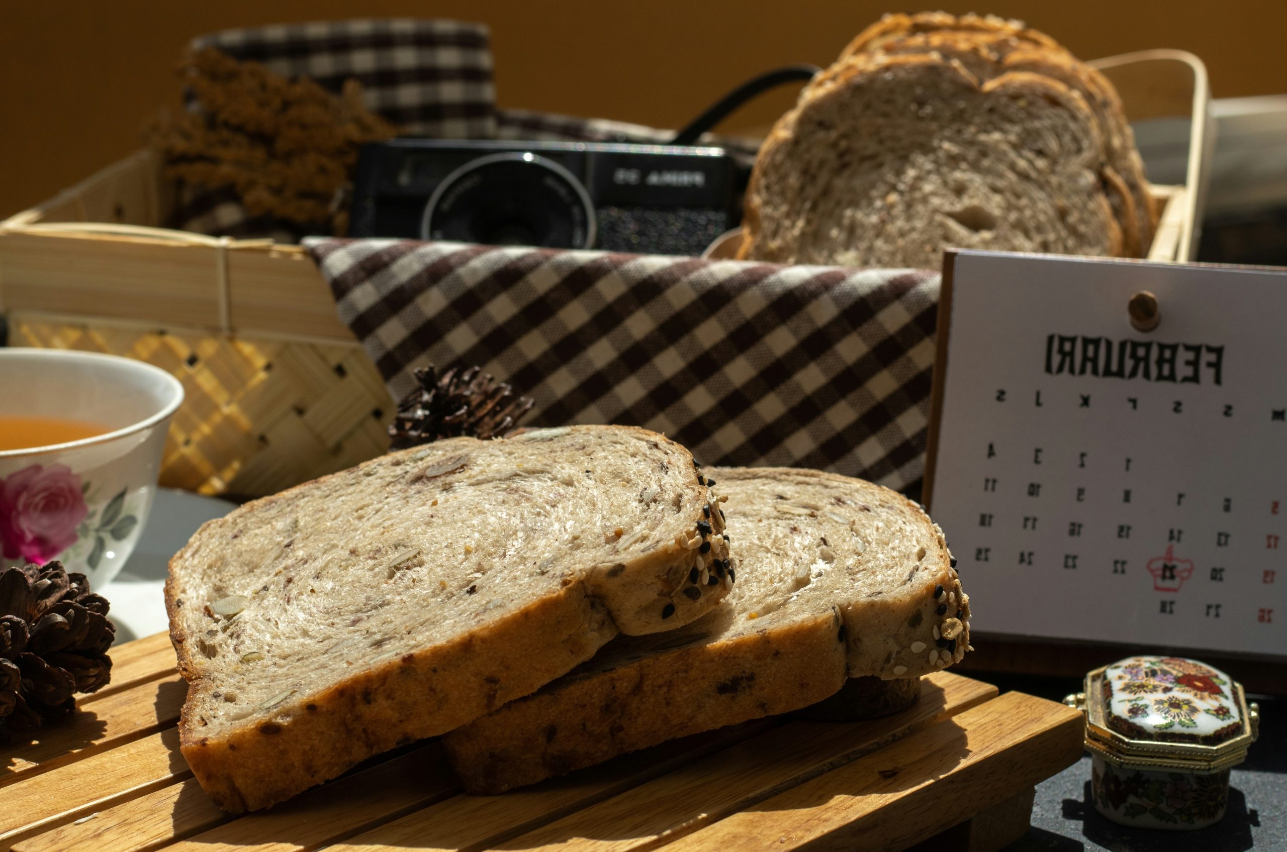 Slices of multi-grain bread on a wooden board.