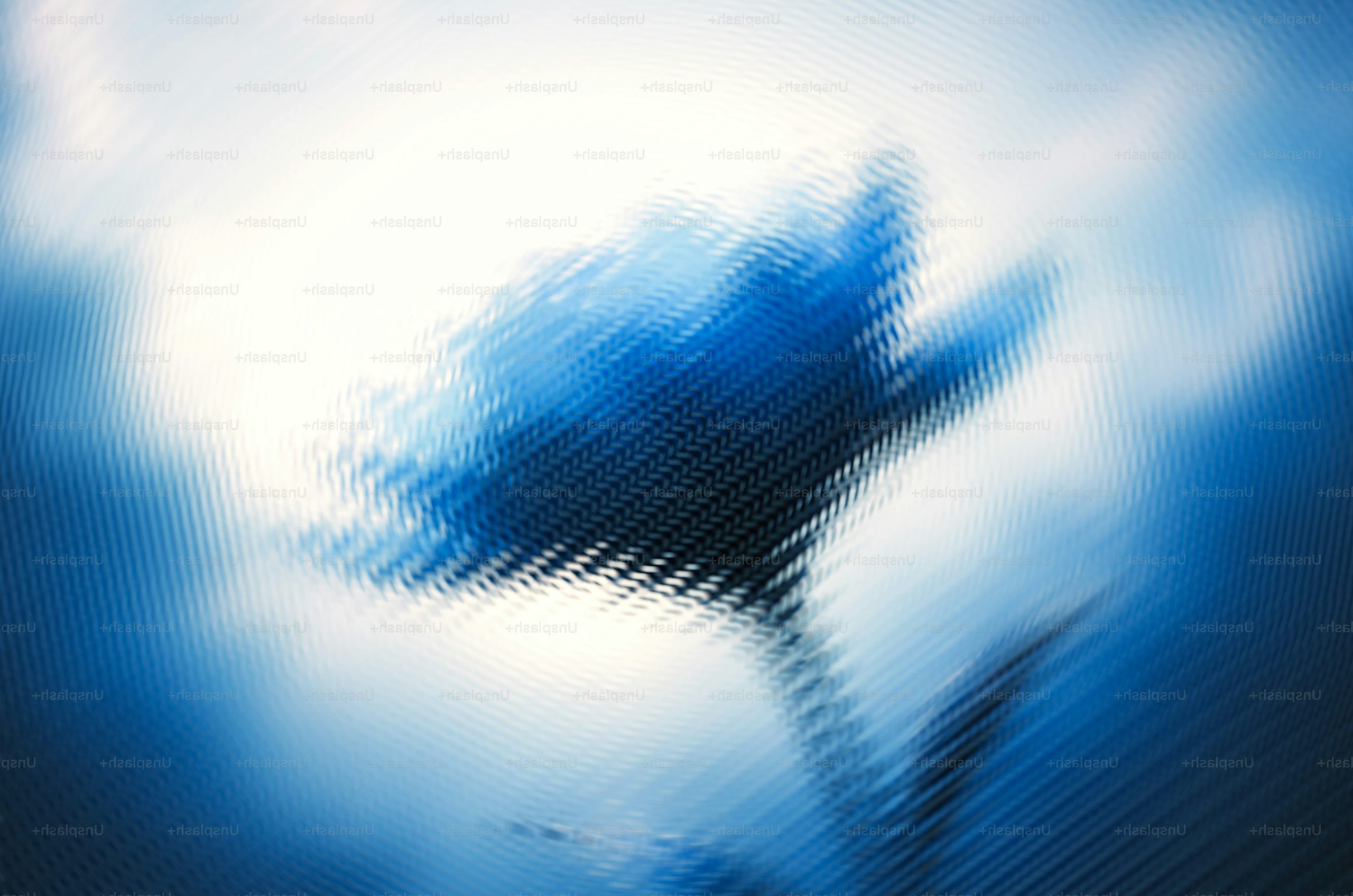 A blue flower silhouette against a bright, rippled, and distorted background.
