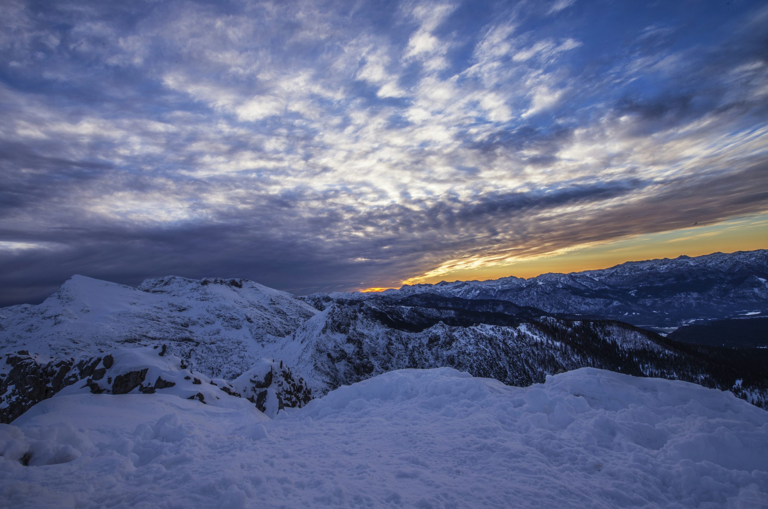 white and black mountain under blue sky at golden hour