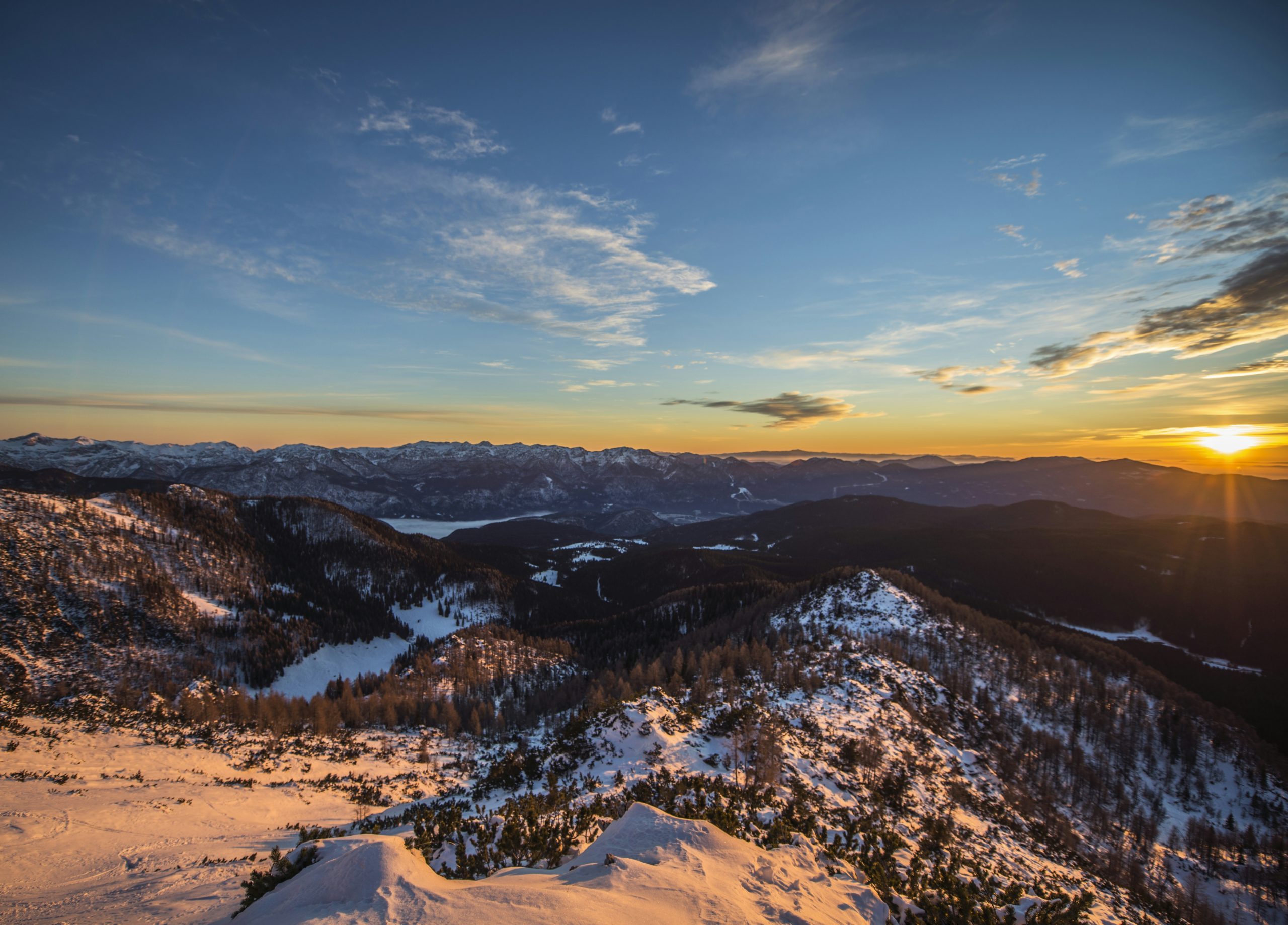 aerial view of trees and mountain during sunset