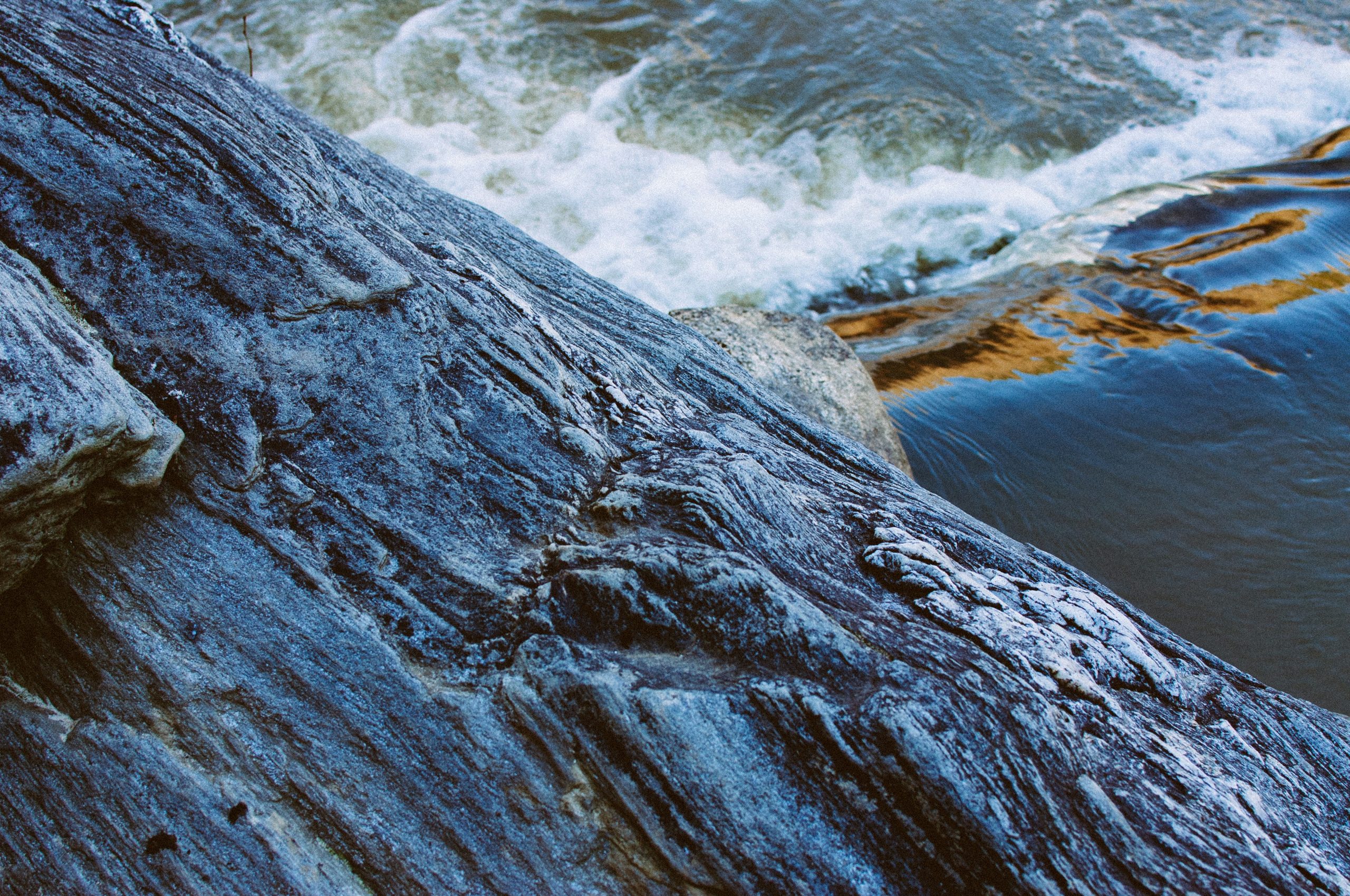 gray rock formation near body of water during daytime