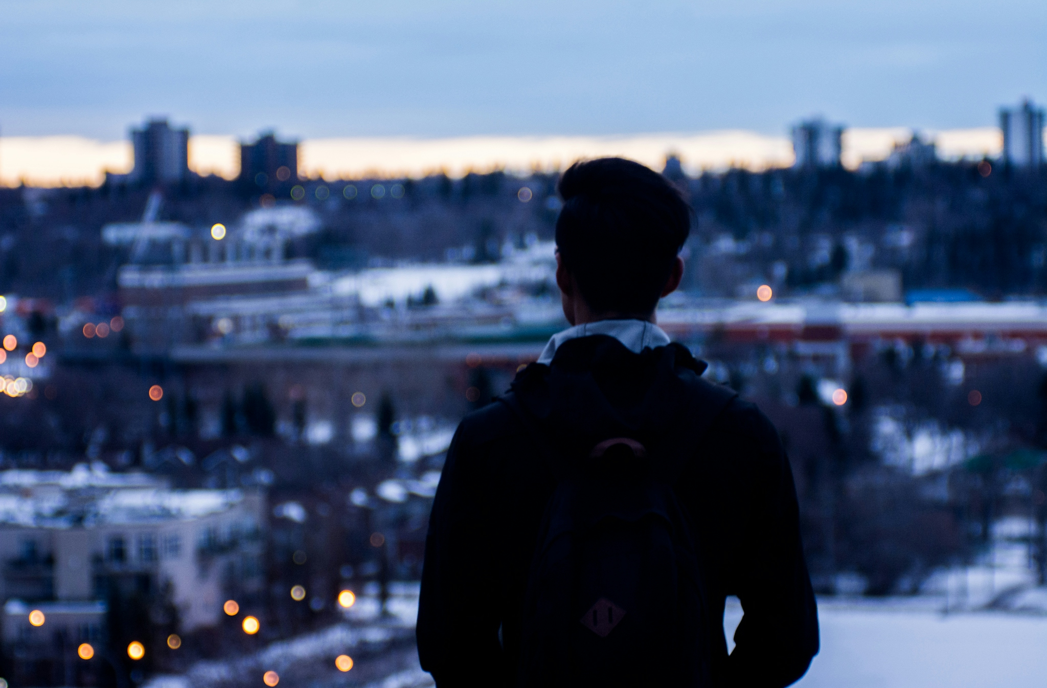 a person looking out over a city at night