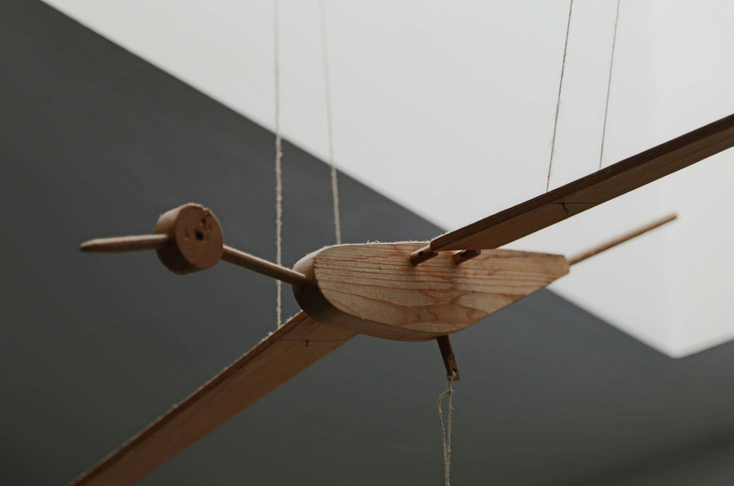 brown wooden clothes hanger on brown metal bar