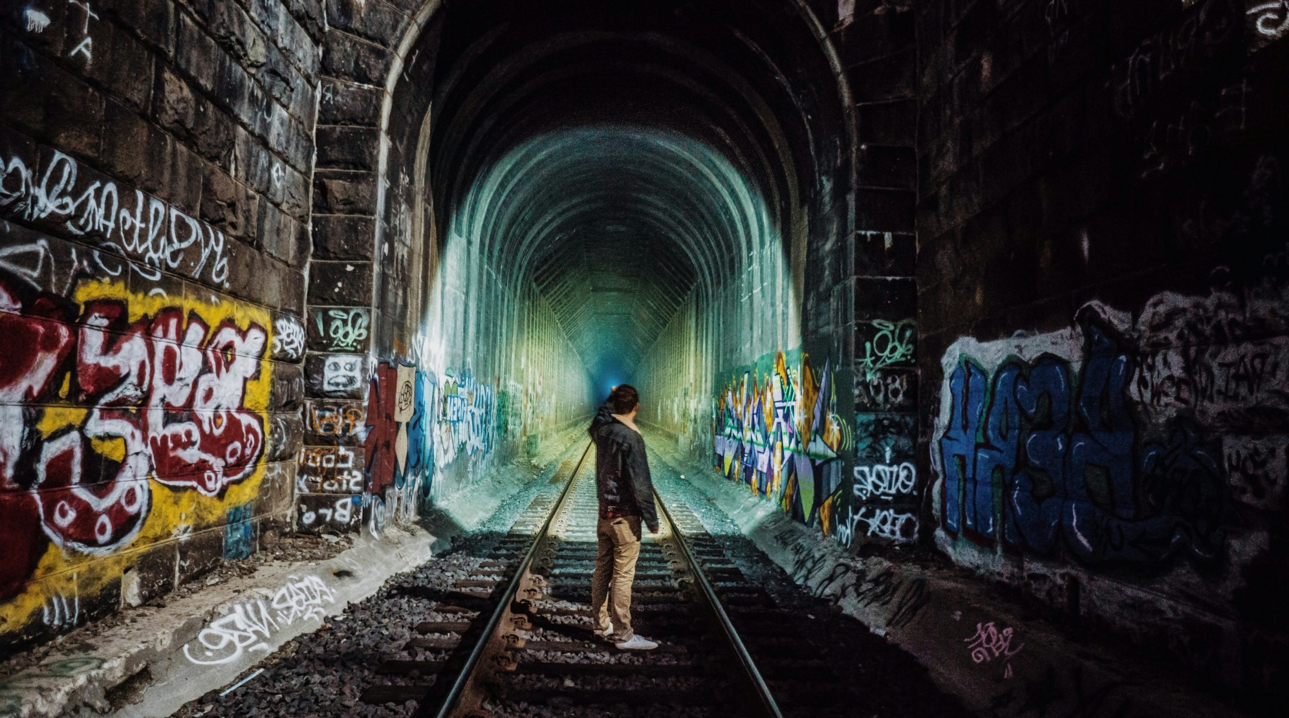 man standing near tunnel