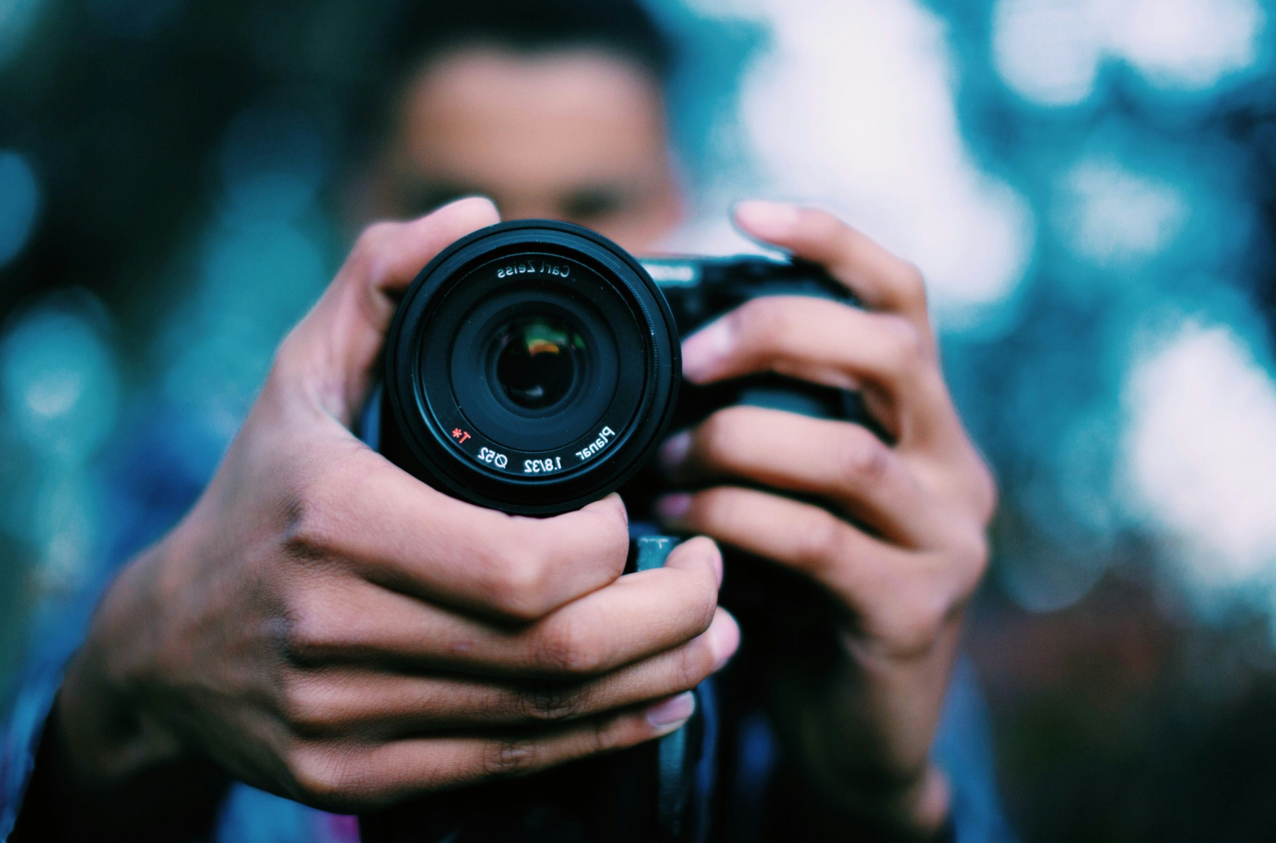 person holding black DSLR camera
