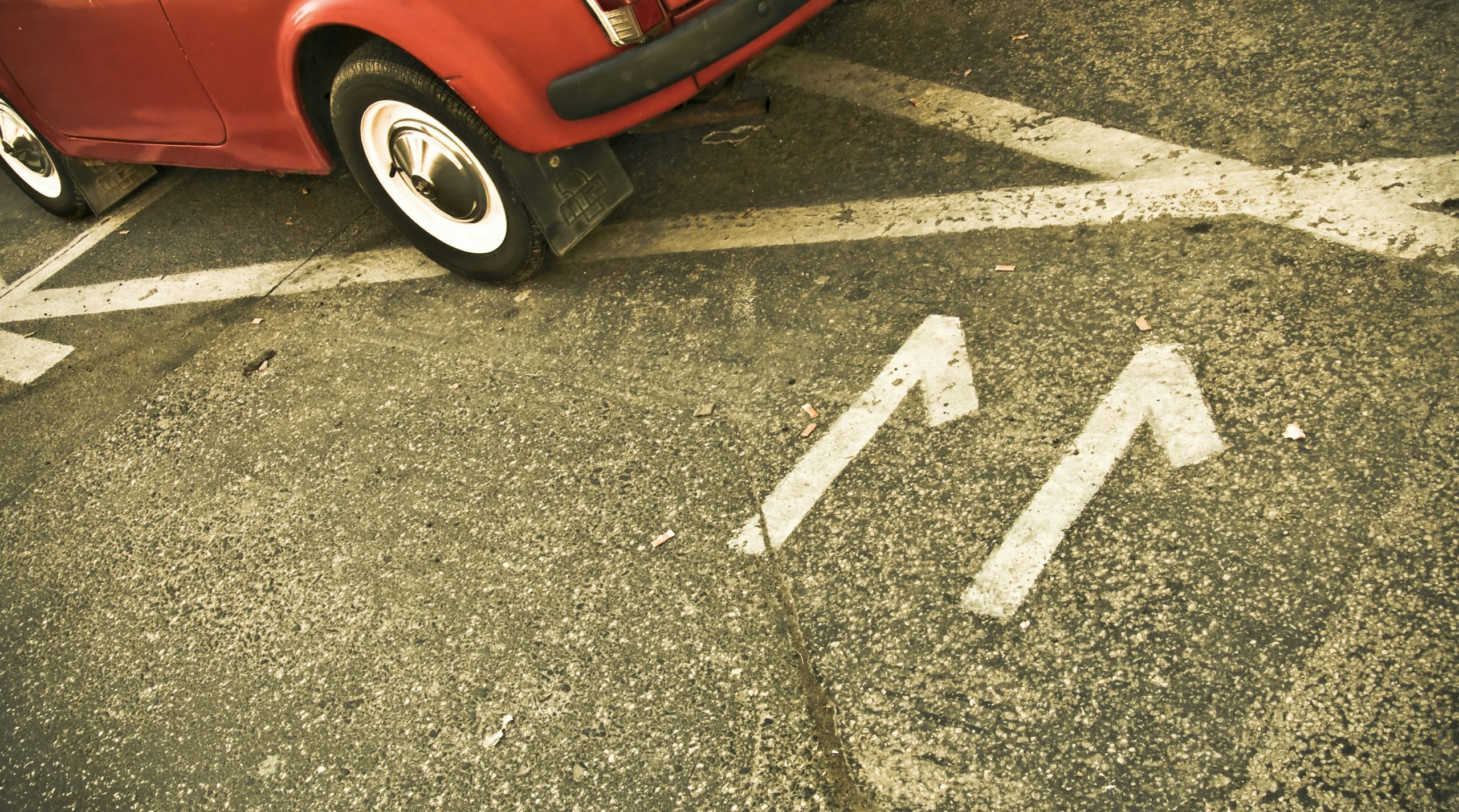 red car on black asphalt road
