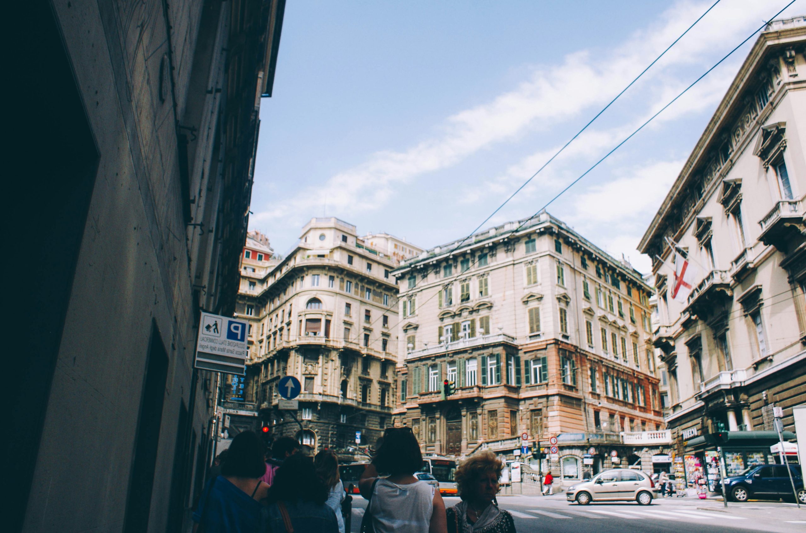people at the street surrounded with buildings during daytime