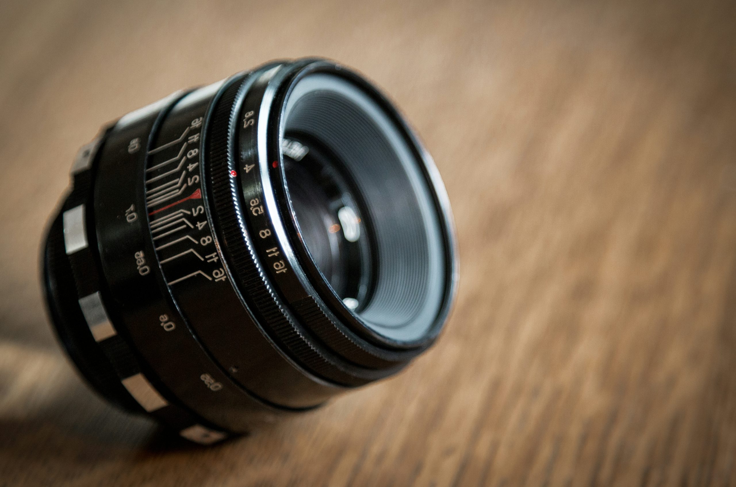 a camera lens sitting on top of a wooden table