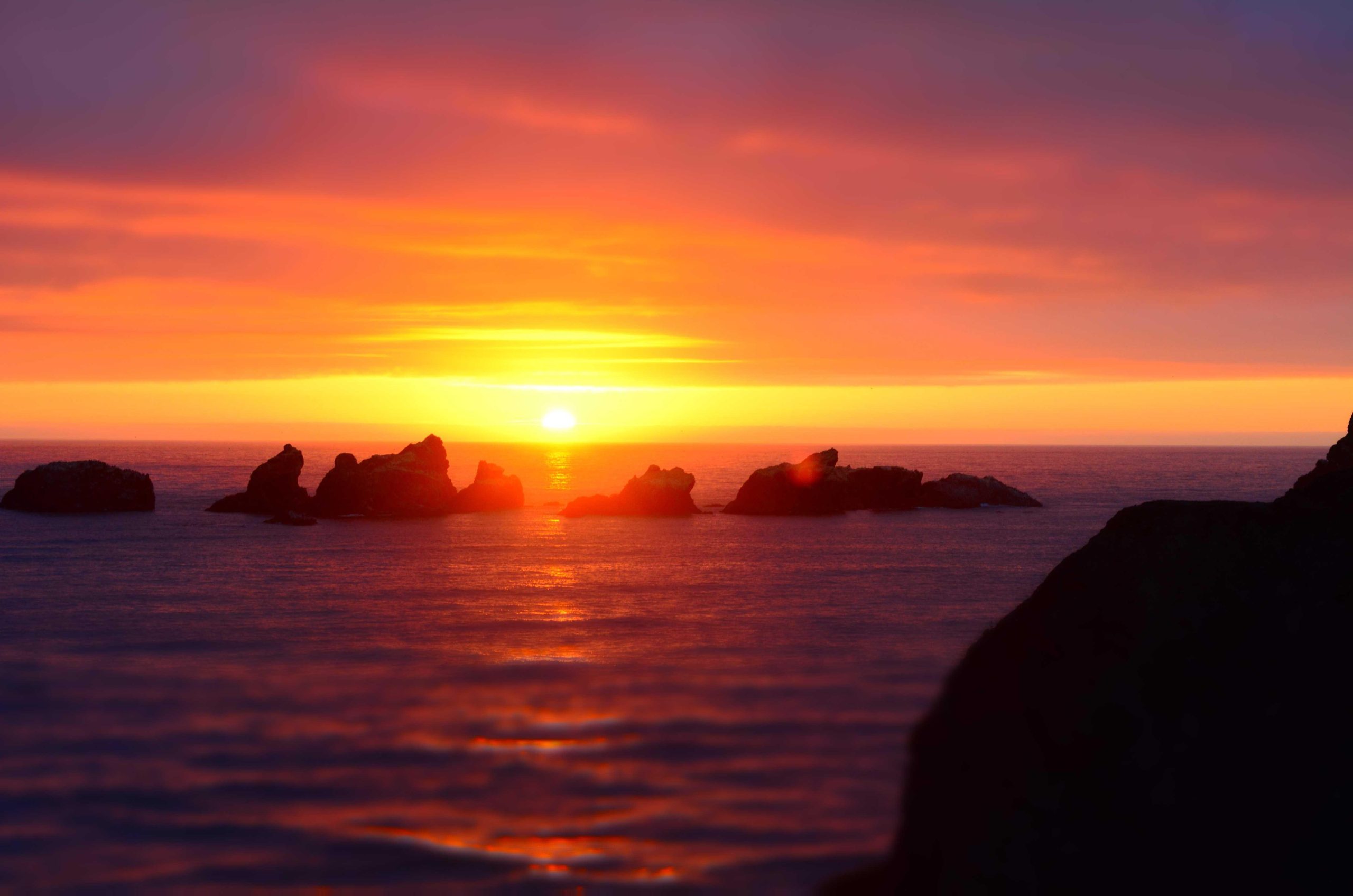 Rocky coastline with jagged cliffs meeting the open sea